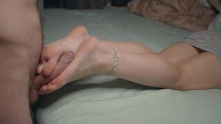 A small-footed girl shows off her feet and performs a foot job