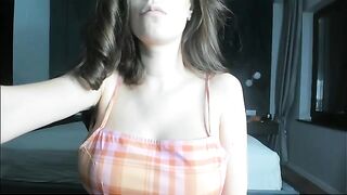 A pregnant girl is caressing her stomach and her nipples, becoming more prominent