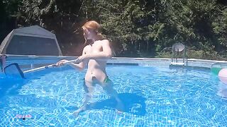 A skinny bikini-clad girl shows off her body by swimming in the pool
