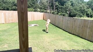 A hot blonde is getting naked in the backyard