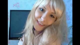 A cute blonde girl caresses her pussy with her fingers in this hot video