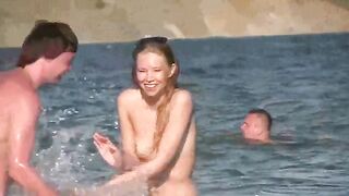 A mature woman goes running naked on the sandy beach