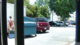 A girl was photographed having sex behind a garbage tank with a hidden camera