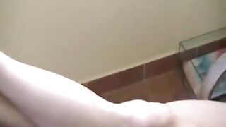 A naked girl with big tits is smoking in the room