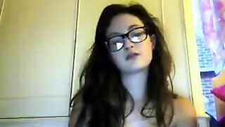 A student with glasses plays with her body during a video chat