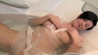 A lonely brunette girl caresses herself in the shower