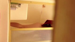 A girl has sex in the shower, unaware of the camera
