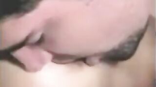 A man has sex with a woman with a strapon, while another plays with him