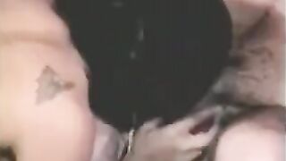 A man has sex with a woman with a strapon, while another plays with him