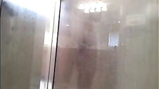 A guy washes his body in the shower, not suspecting a thing