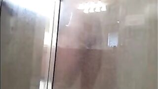 A guy washes his body in the shower, not suspecting a thing