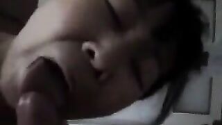 A Chinese woman practices her blowjob skills on him, showcasing her passion in a steamy homemade scene