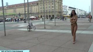 A hot girl is walking naked in the city streets