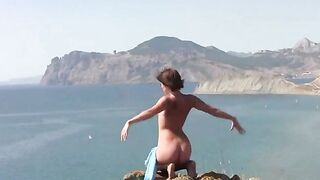 A young girl shows her body on the beach without any clothes