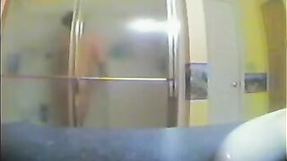 A girl has no idea that someone films her in the shower