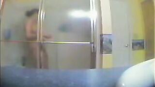 A girl has no idea that someone films her in the shower