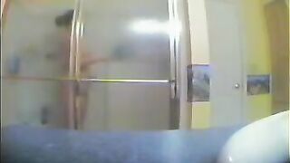 A girl has no idea that someone films her in the shower