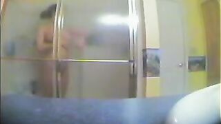 A girl has no idea that someone films her in the shower