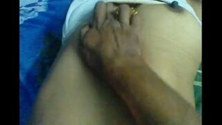 A husband massages the nipples of his wife in a sensual and intimate act