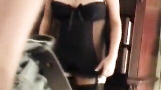 A husband shoots his wife in corset porn, showcasing their intimate bedroom dynamics