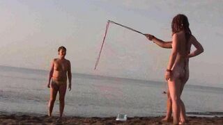 Nude beauty playing on the beach without any clothes