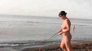 Nude beauty playing on the beach without any clothes