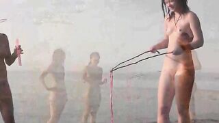 Nude beauty playing on the beach without any clothes