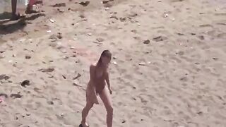 A naked couple enjoying sex on the seashore