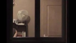 He looks at himself in the mirror and admires his naked body