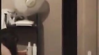 He looks at himself in the mirror and admires his naked body