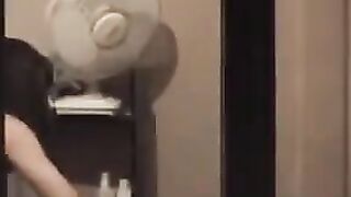He looks at himself in the mirror and admires his naked body