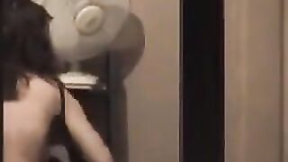 He looks at himself in the mirror and admires his naked body