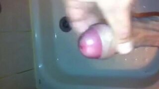 The kid caresses his cock with his hand in the shower