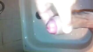 The kid caresses his cock with his hand in the shower