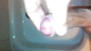 The kid caresses his cock with his hand in the shower