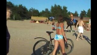 Nudists enjoy each other on the beach