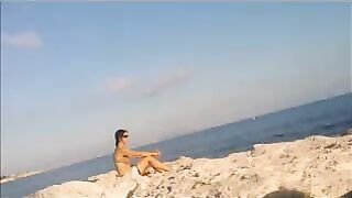 A young girl sunbathes naked on the beach, it's not forbidden