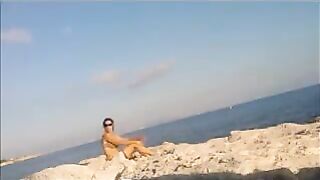 A young girl sunbathes naked on the beach, it's not forbidden