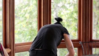 Vietnamese beauty fucked in the kitchen by a horny lesbian with a strap-on