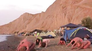 A group of naked beauties playing volleyball on the beach