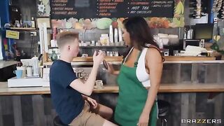 A girl with big boobs is working as a barista in the coffee shop
