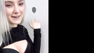 Girl received a cumshot on the face through the glory hole fitting room