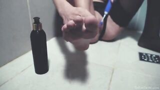 In the shower, a naked woman plays with sex toys and has fun